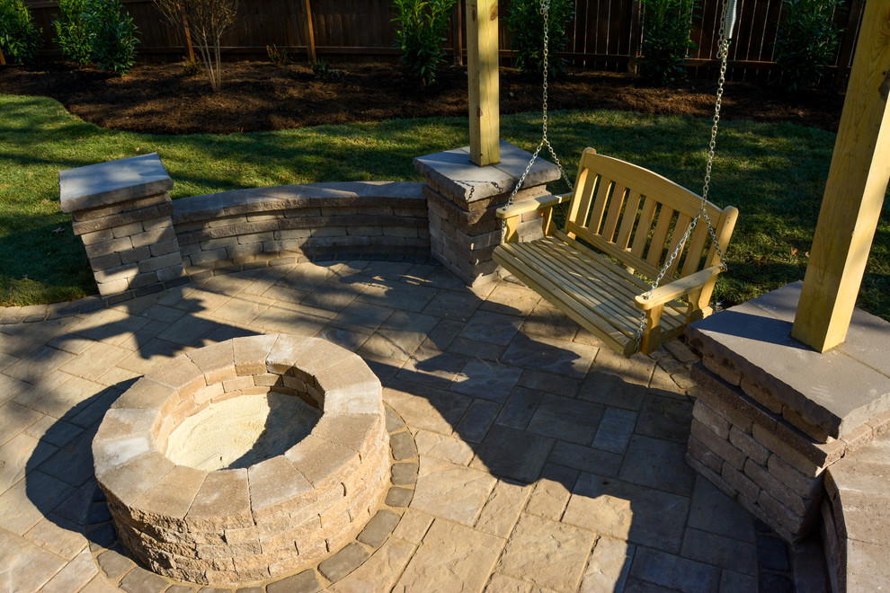 Mid-sized traditional backyard patio in Richmond with a fire feature, concrete pavers and no cover.