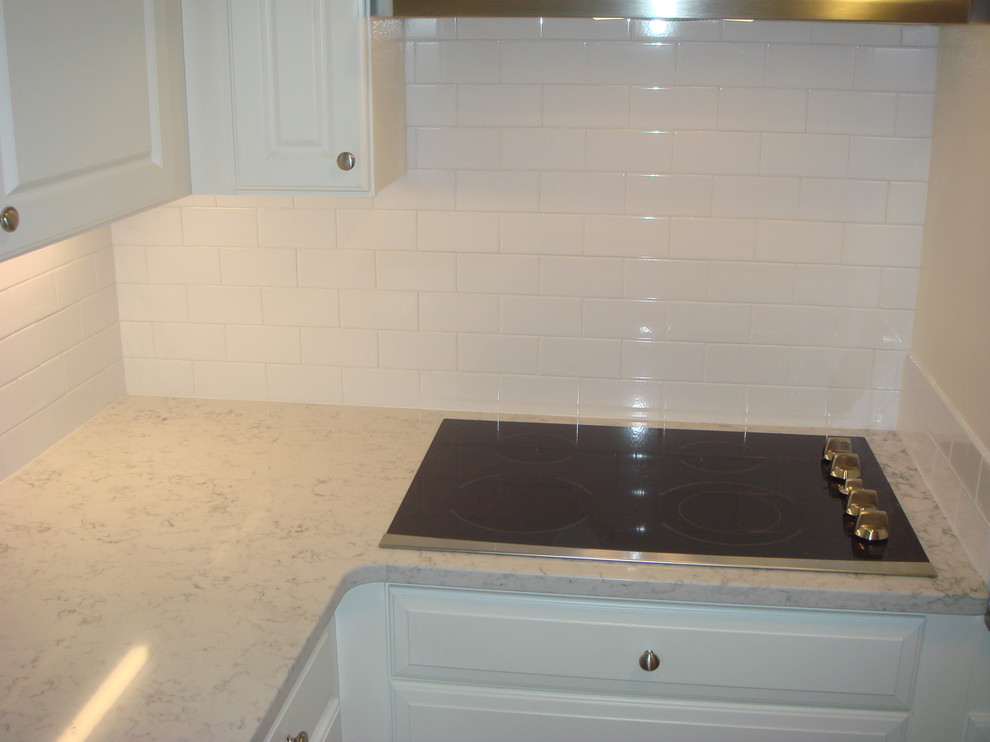 Elegant kitchen photo in Baltimore with raised-panel cabinets, white cabinets, granite countertops, white backsplash and subway tile backsplash