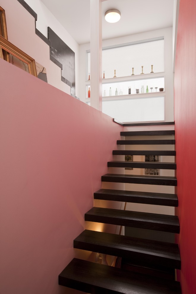 This is an example of a contemporary staircase in Kansas City with open risers.