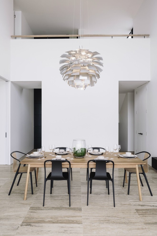 Contemporary dining room in Auckland with white walls and beige floor.