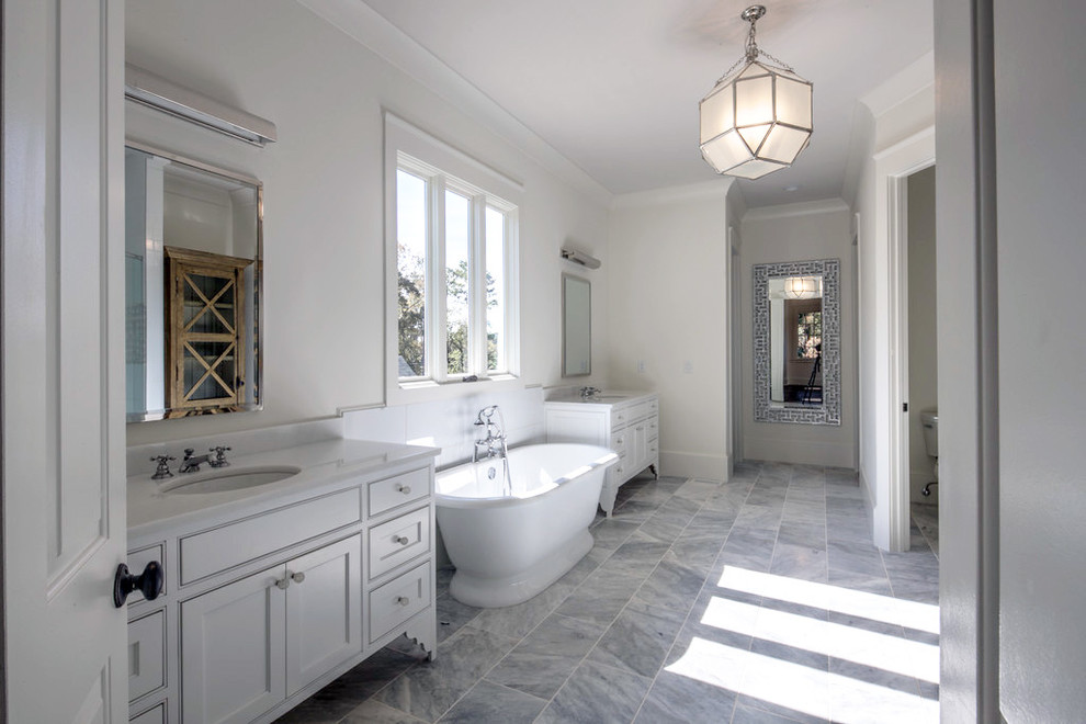 Large transitional master bathroom in Atlanta with recessed-panel cabinets, white cabinets, a freestanding tub, an alcove shower, beige tile, white tile, ceramic tile, white walls, marble floors, an undermount sink and engineered quartz benchtops.