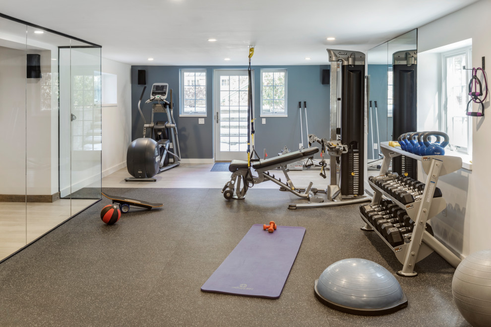 Large transitional home weight room in Boston with blue walls and multi-coloured floor.