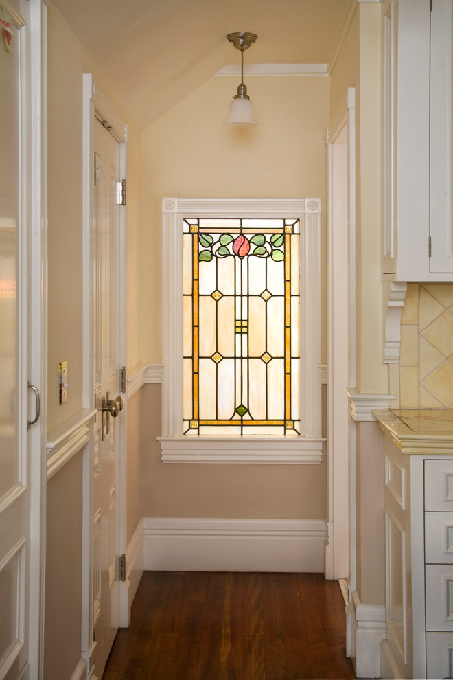Design ideas for a traditional hallway in Santa Barbara with beige walls and dark hardwood floors.