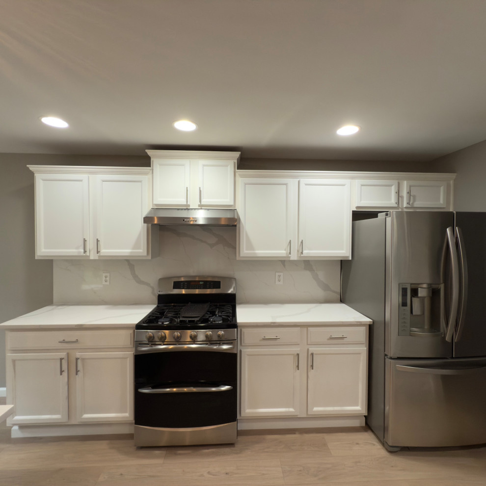 Inspiration for a transitional single-wall eat-in kitchen remodel in Seattle with shaker cabinets, white cabinets, quartz countertops, stainless steel appliances, an island and white countertops