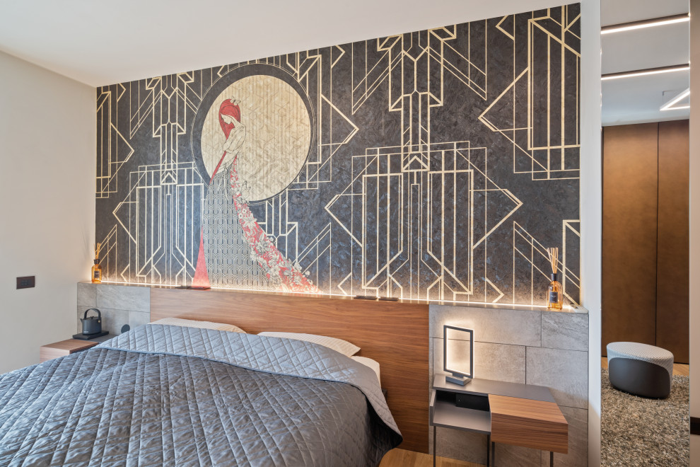 This is an example of a large contemporary bedroom in Milan with multi-coloured walls, light hardwood floors, no fireplace, multi-coloured floor, wood and wallpaper.