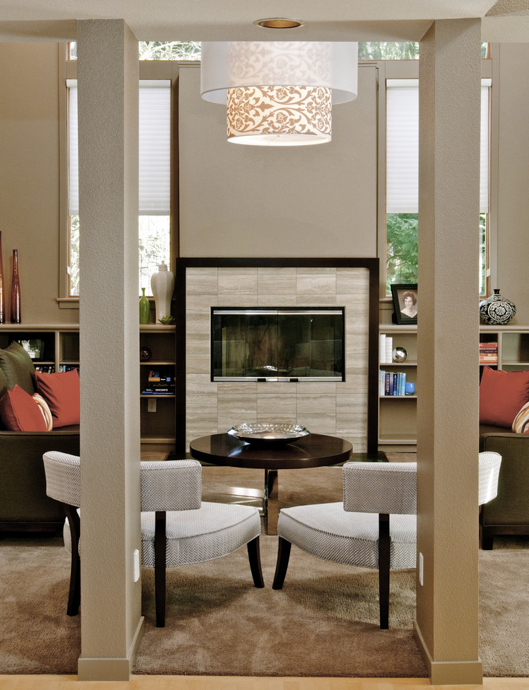 Photo of a contemporary living room in Other with a library, beige walls and a standard fireplace.