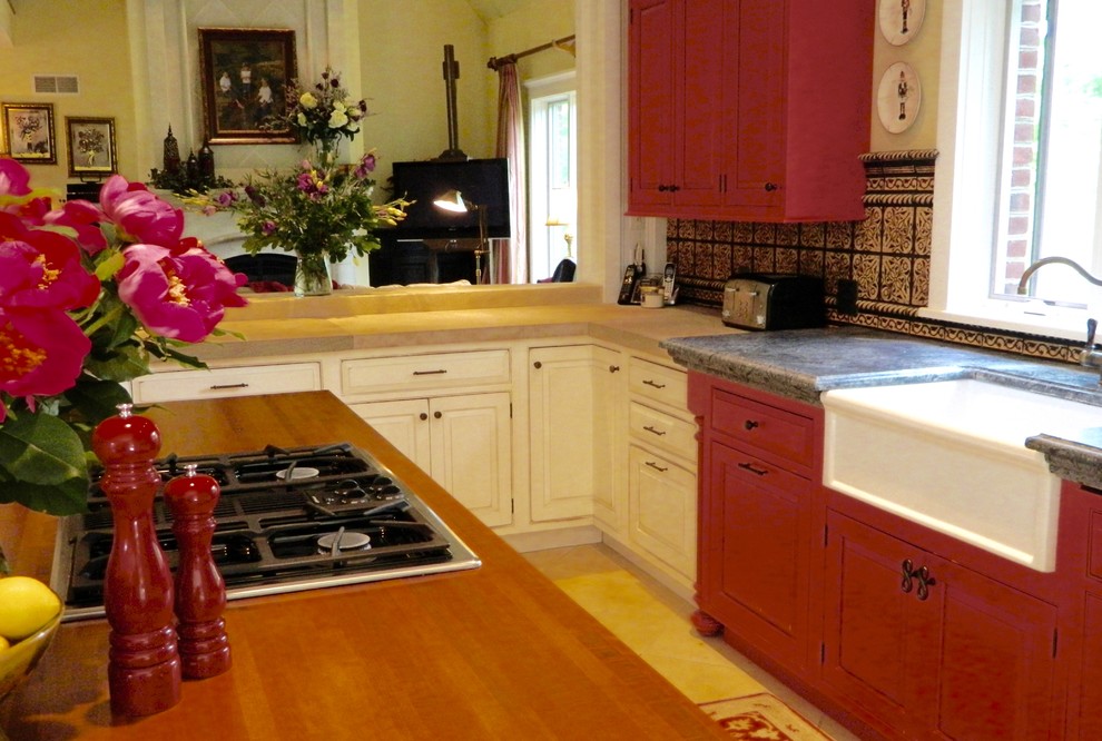 Design ideas for a large traditional l-shaped separate kitchen in Other with a farmhouse sink, beaded inset cabinets, red cabinets, soapstone benchtops, multi-coloured splashback, terra-cotta splashback, panelled appliances, limestone floors and with island.
