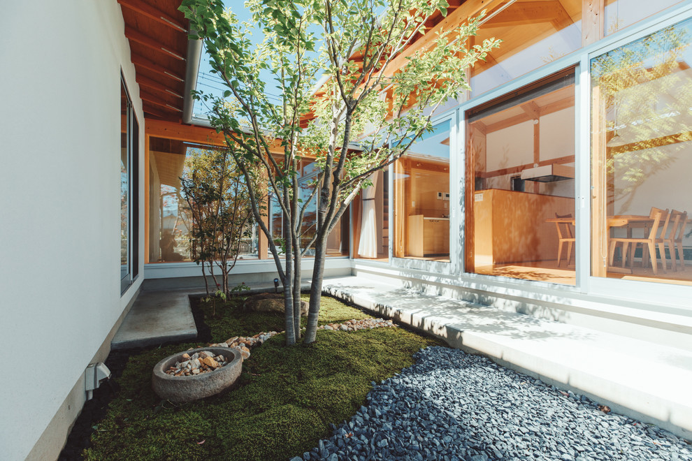 This is an example of an asian courtyard patio in Other with concrete slab.