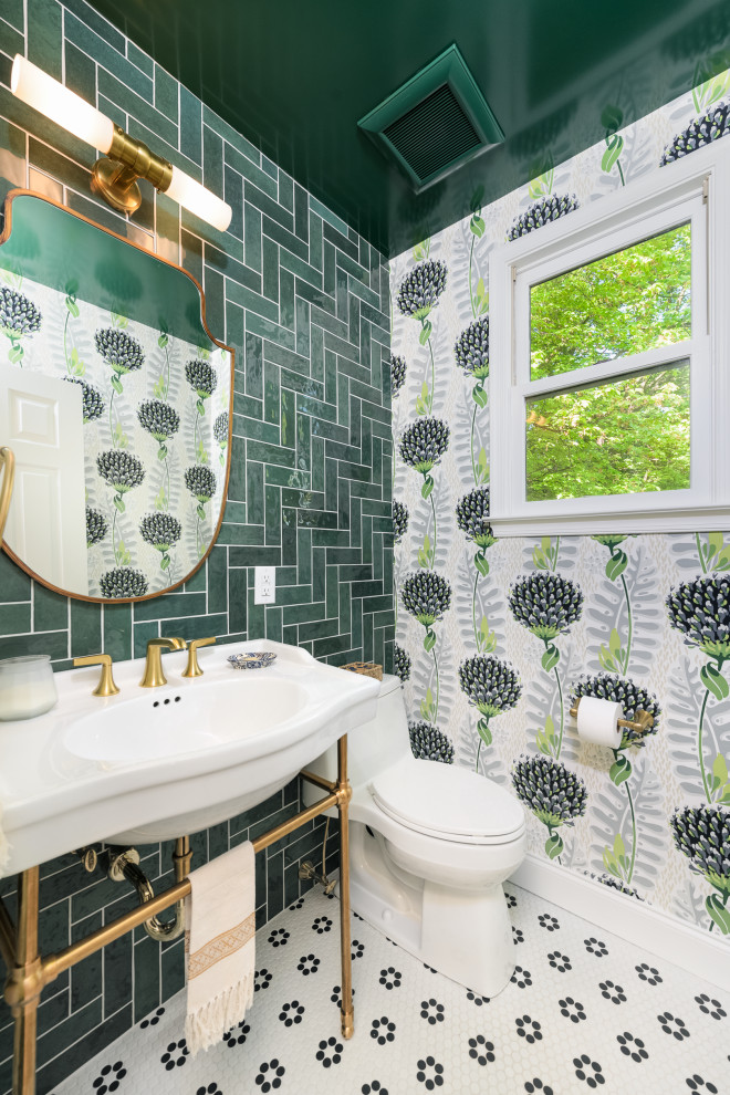 Photo of a large transitional powder room in Philadelphia with open cabinets, white cabinets, a one-piece toilet, green tile, porcelain tile, green walls, mosaic tile floors, a console sink, white floor, white benchtops, a freestanding vanity, wallpaper and wallpaper.