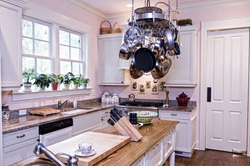 Mid-sized medium tone wood floor eat-in kitchen photo in Minneapolis with an undermount sink, white cabinets, white backsplash, paneled appliances and an island