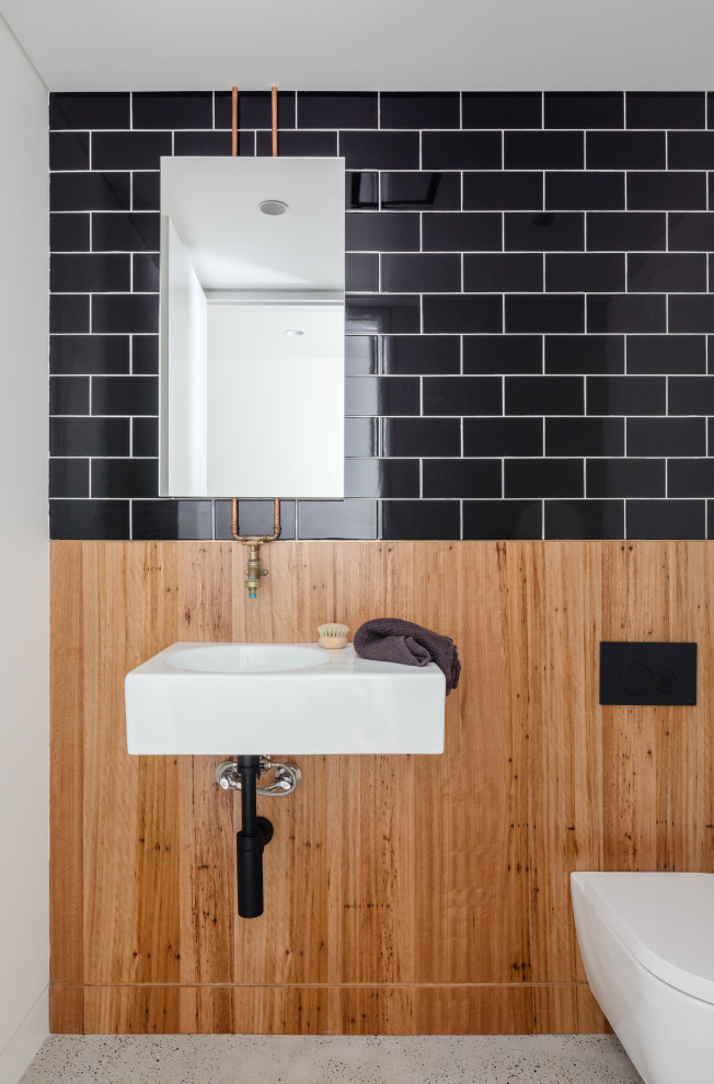 Design ideas for a small industrial powder room in Sydney with a floating vanity.