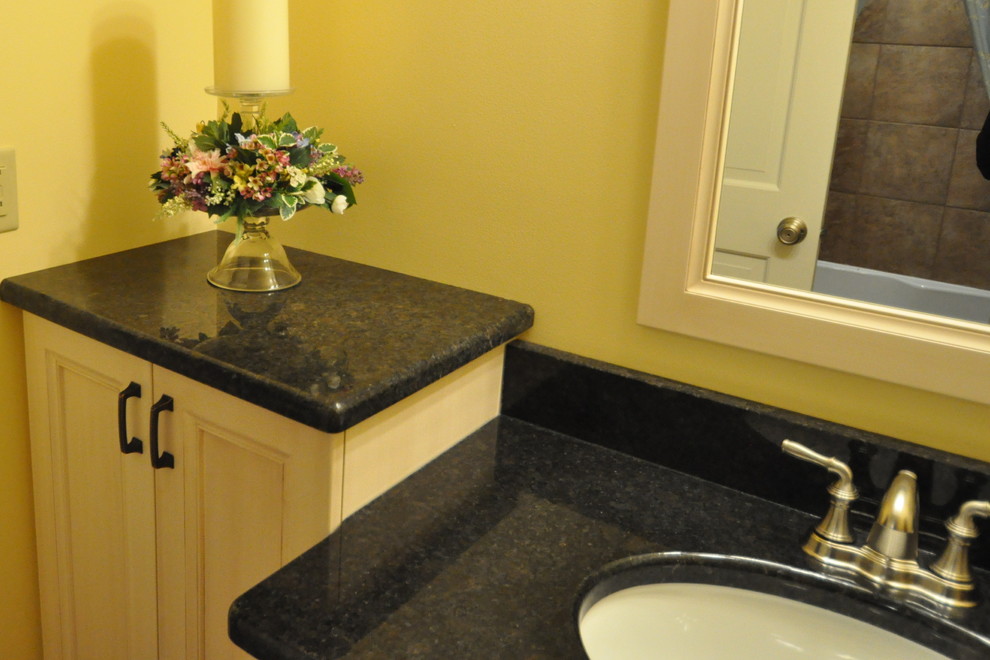 Inspiration for a transitional porcelain tile alcove bathtub remodel in Chicago with an undermount sink and flat-panel cabinets