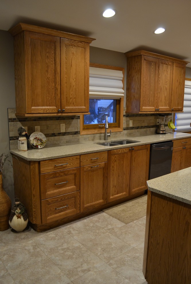 Example of a mid-sized transitional galley eat-in kitchen design with an undermount sink, flat-panel cabinets, medium tone wood cabinets, quartz countertops, beige backsplash, porcelain backsplash, stainless steel appliances and no island