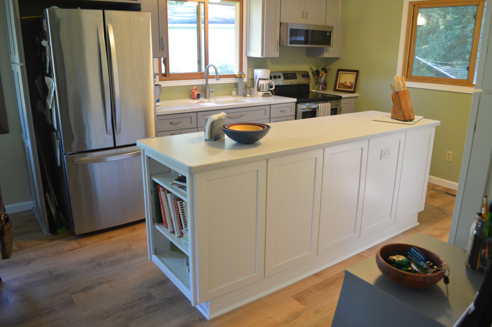 Eat-in kitchen - small transitional single-wall vinyl floor eat-in kitchen idea with an undermount sink, shaker cabinets, gray cabinets, solid surface countertops, stainless steel appliances, an island and white countertops