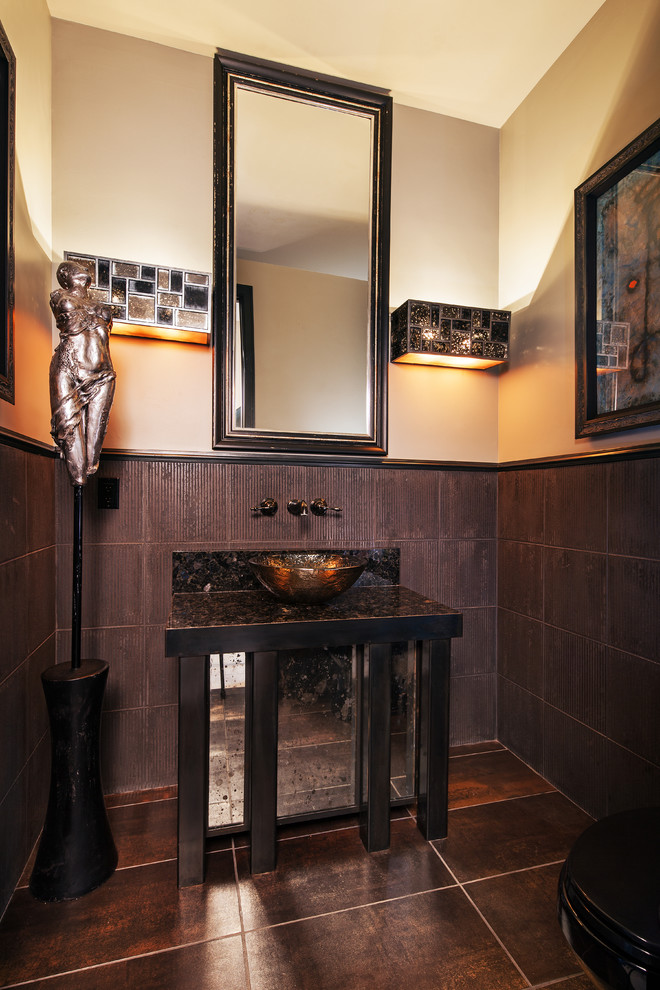 Photo of a contemporary powder room in Other with a vessel sink, furniture-like cabinets, brown tile and beige walls.