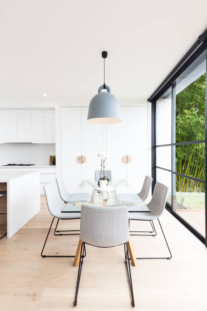 Inspiration for a scandinavian kitchen/dining combo in Melbourne with white walls, light hardwood floors and beige floor.