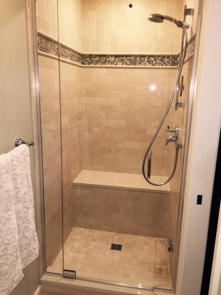 Inspiration for a mid-sized transitional master travertine floor and beige floor alcove shower remodel with shaker cabinets, brown cabinets, beige walls, an undermount sink, quartz countertops and a hinged shower door