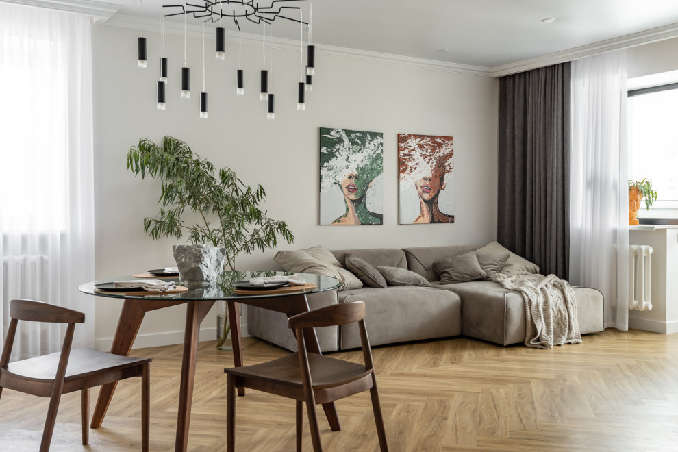 This is an example of a contemporary open concept living room in Other with beige walls and beige floor.