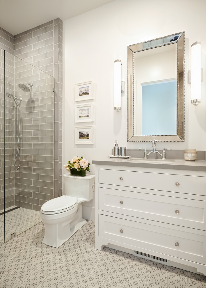 Inspiration for a country 3/4 bathroom in San Francisco with shaker cabinets, white cabinets, a one-piece toilet, gray tile, subway tile, white walls, porcelain floors, an undermount sink, engineered quartz benchtops, grey floor, a hinged shower door, grey benchtops and an alcove shower.