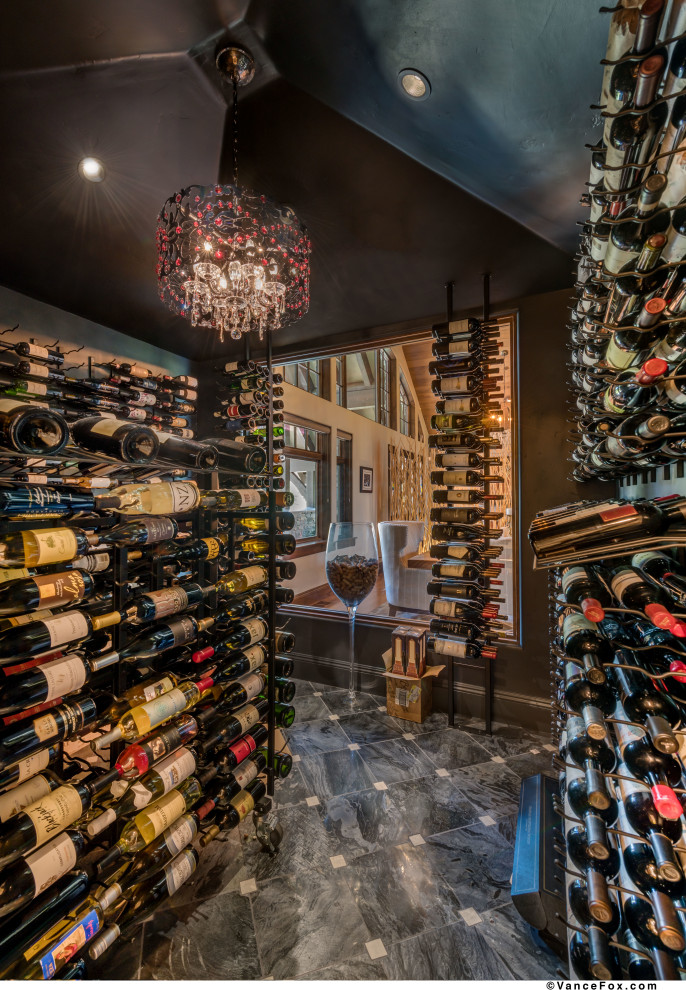 Design ideas for a large country wine cellar in Other with slate floors, storage racks and black floor.