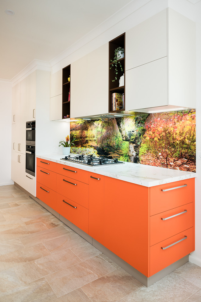 Design ideas for a mid-sized modern galley separate kitchen in Melbourne with a double-bowl sink, flat-panel cabinets, orange cabinets, white splashback, glass sheet splashback, stainless steel appliances, porcelain floors and beige floor.