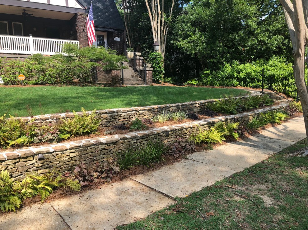 This is an example of a classic partial sun garden in Birmingham with a retaining wall.