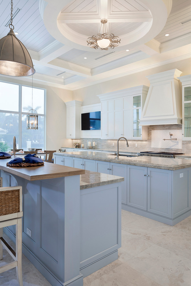Large transitional u-shaped open plan kitchen in Miami with an undermount sink, recessed-panel cabinets, purple cabinets, marble benchtops, multi-coloured splashback, subway tile splashback, stainless steel appliances, porcelain floors, multiple islands, beige floor and beige benchtop.