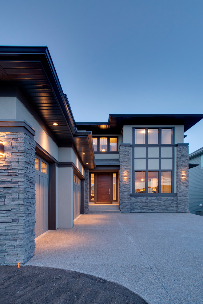 Contemporary two-storey grey exterior in Calgary with wood siding.