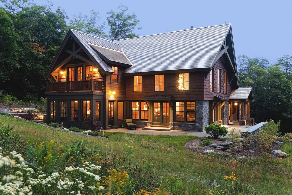 Photo of a country two-storey brown exterior in Burlington with wood siding.