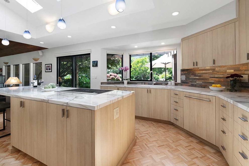 This is an example of a large contemporary l-shaped kitchen/diner in San Francisco with a submerged sink, flat-panel cabinets, light wood cabinets, multi-coloured splashback, stone tiled splashback, integrated appliances, plywood flooring, an island, beige floors, white worktops and a vaulted ceiling.
