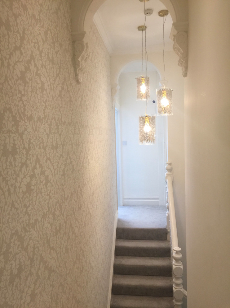 Inspiration for a mid-sized modern carpeted straight staircase in Cardiff with carpet risers, wood railing and wallpaper.
