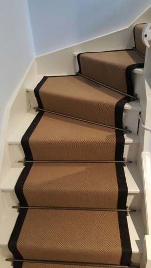 Design ideas for a mid-sized transitional carpeted u-shaped staircase in London with carpet risers.