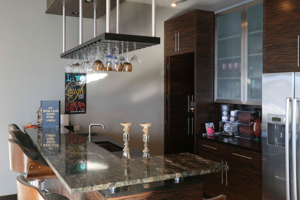 Example of a large transitional galley porcelain tile and beige floor kitchen design with an undermount sink, flat-panel cabinets, dark wood cabinets, granite countertops, black backsplash, porcelain backsplash and black countertops