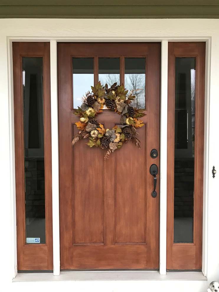 Small traditional front door in Other with a single front door and a medium wood front door.