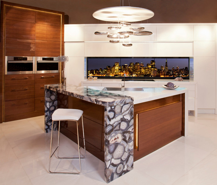 Mid-sized modern l-shaped eat-in kitchen in Toronto with an undermount sink, medium wood cabinets, marble benchtops, stainless steel appliances, marble floors, with island, flat-panel cabinets and multi-coloured splashback.