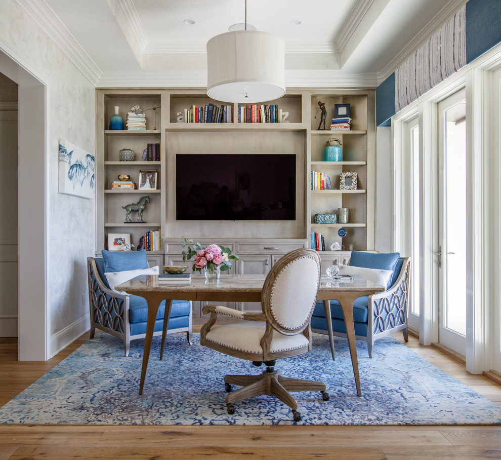 Inspiration for a beach style study room in Jacksonville with grey walls, medium hardwood floors, a freestanding desk and brown floor.