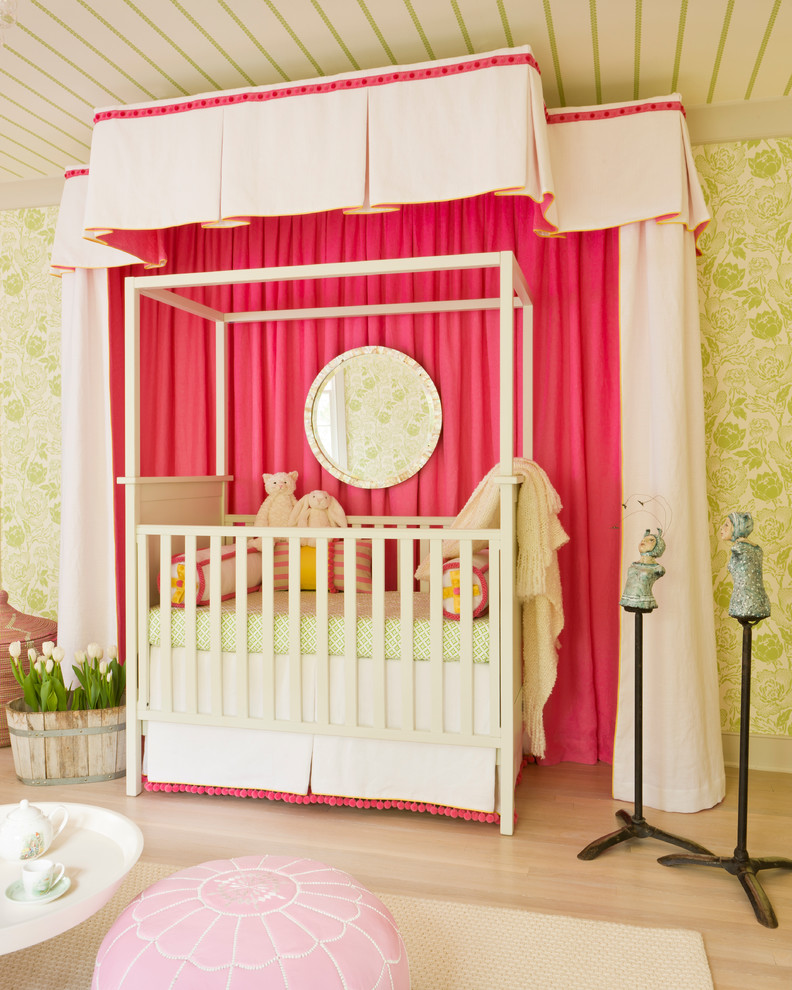 Inspiration for a transitional nursery for girls in DC Metro with light hardwood floors, green walls and beige floor.