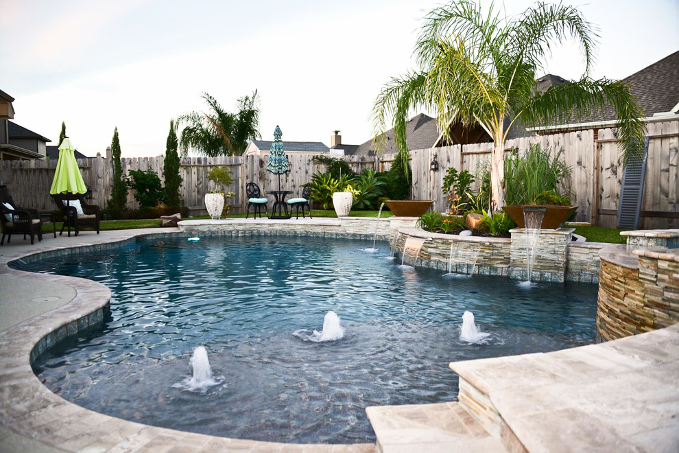 Inspiration for a large modern backyard custom-shaped pool in Houston with a hot tub and stamped concrete.