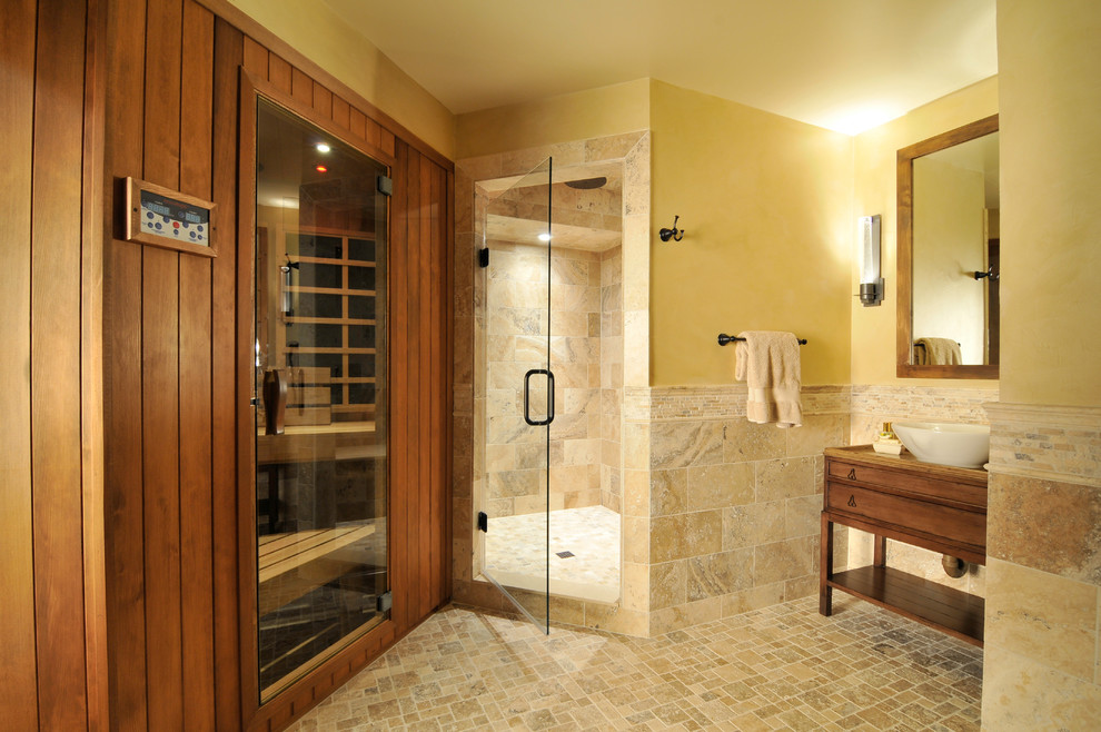 This is an example of a traditional bathroom with a vessel sink, furniture-like cabinets, medium wood cabinets, granite benchtops, a two-piece toilet, yellow walls, brown tile and with a sauna.