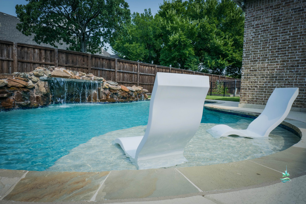 Foto de piscina natural de estilo americano de tamaño medio a medida en patio trasero con privacidad y suelo de hormigón estampado