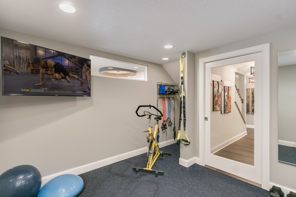 Photo of a mid-sized transitional multipurpose gym in Minneapolis with grey walls, cork floors and blue floor.