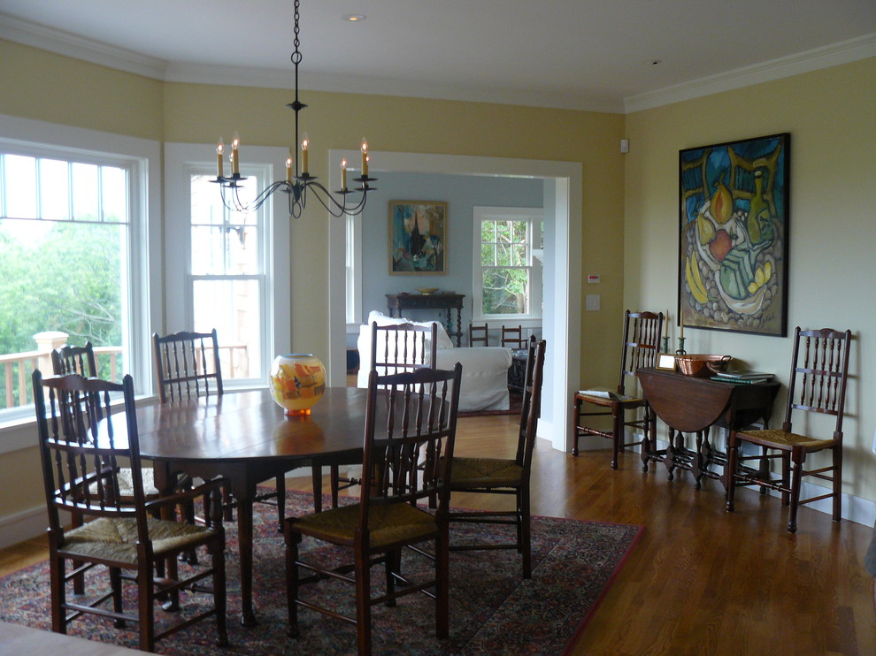 Mid-sized transitional dark wood floor kitchen/dining room combo photo in Providence with yellow walls and no fireplace