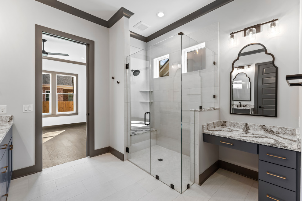Example of a mid-sized transitional master white floor corner shower design with flat-panel cabinets, gray cabinets, quartz countertops, a hinged shower door, gray countertops and a built-in vanity