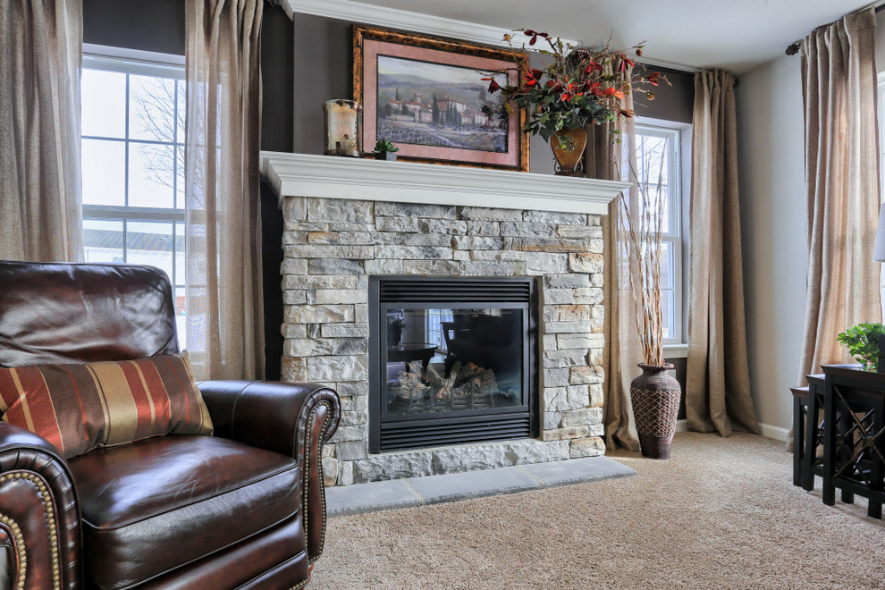 Home design - mid-sized rustic open concept carpeted home design idea with gray walls, a standard fireplace and a stone fireplace