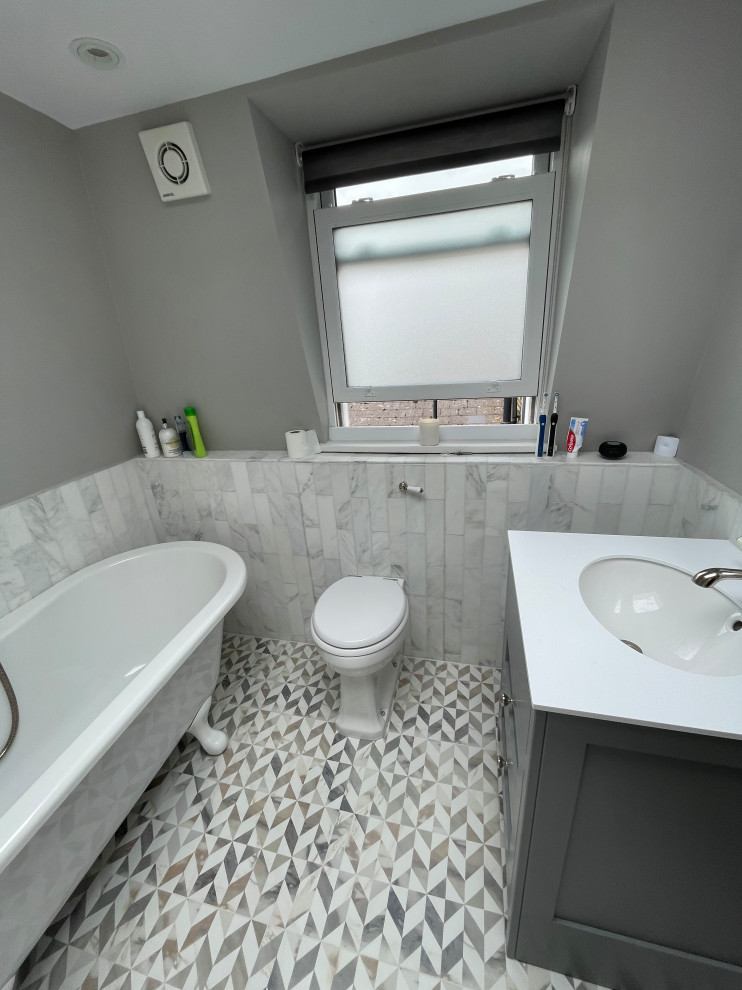 This is an example of a medium sized traditional family bathroom in London with shaker cabinets, grey cabinets, a claw-foot bath, a one-piece toilet, quartz worktops, a single sink and a freestanding vanity unit.