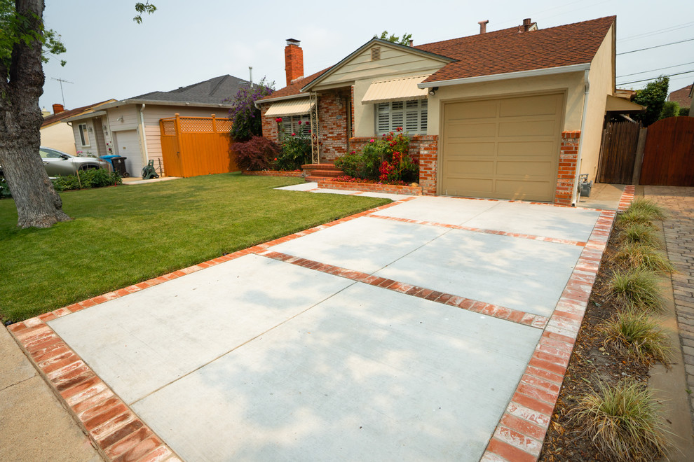 This is an example of a large country front yard partial sun driveway in San Francisco with a retaining wall and brick pavers.