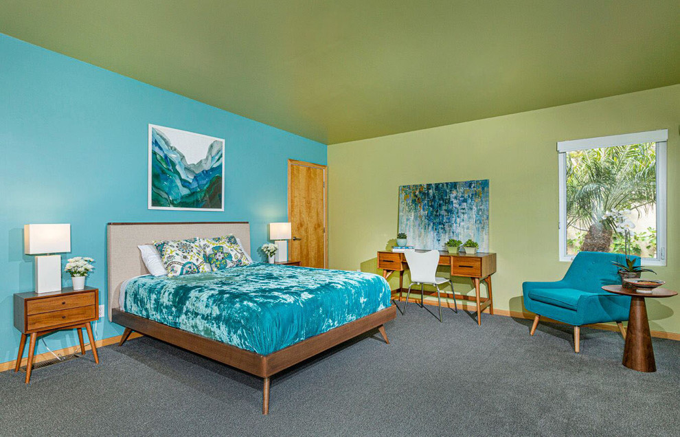 This is an example of a large contemporary bedroom in San Diego with blue walls, carpet and grey floor.