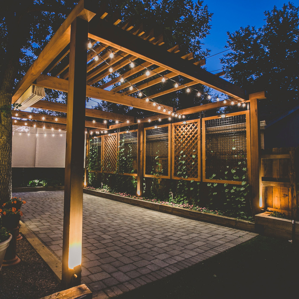 Inspiration for a large traditional backyard patio in Denver with a vertical garden, concrete pavers and a pergola.