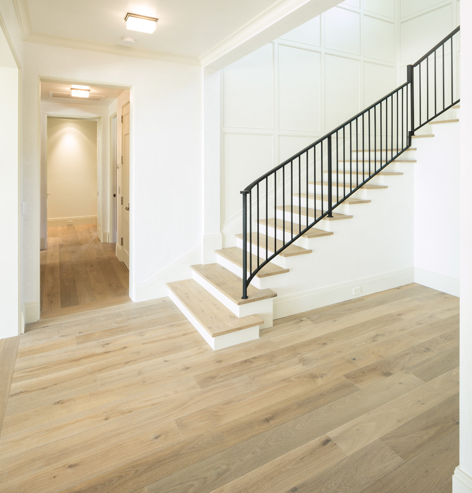 Inspiration for a mid-sized traditional metal curved staircase in Miami with wood risers.