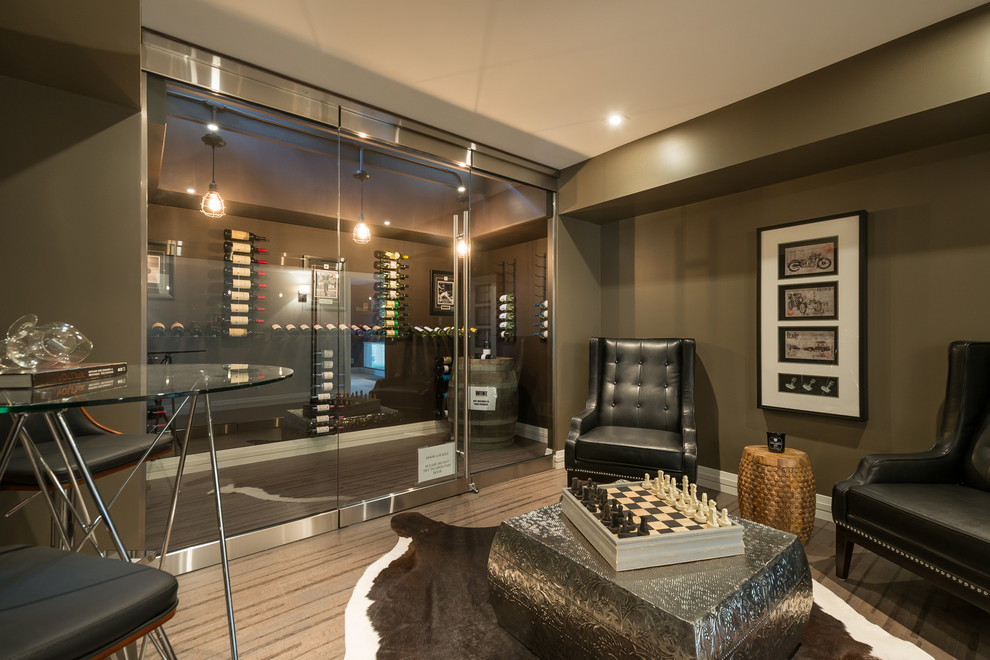 This is an example of a transitional wine cellar in Toronto with carpet and display racks.